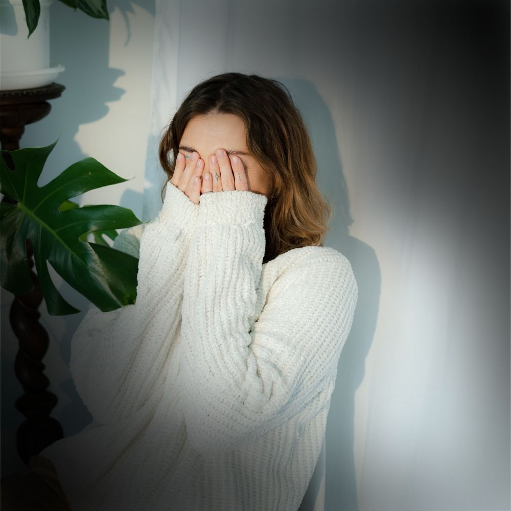 Embarrassed Woman holding face in embarrassment